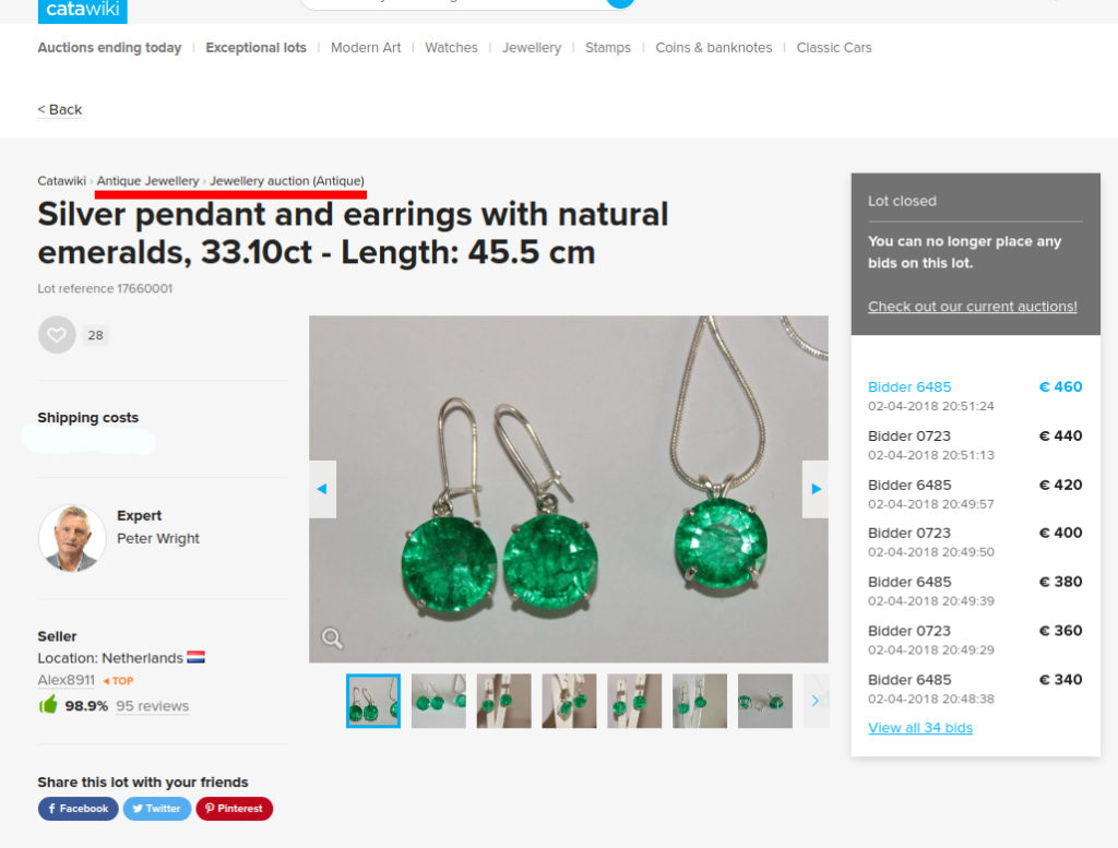 Silver earrings and a pendant with fake emeralds sold as antique jewelry